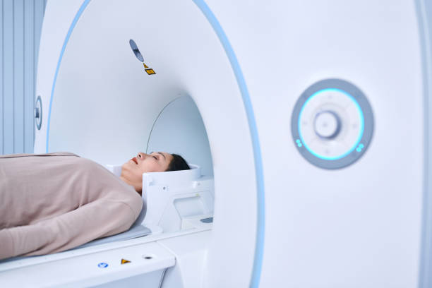 Side view of one asia female patient receiving MRI scan.